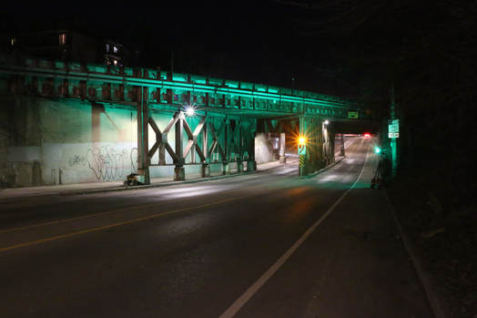 The Young Street rail bridge lit up in green.